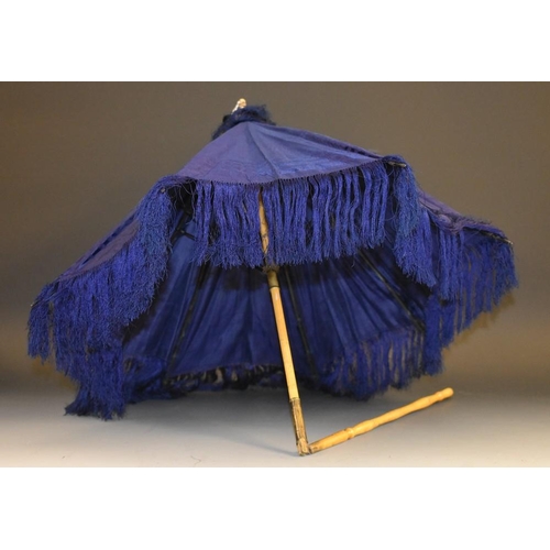 3391 - A late 19th Century hinged carriage parasol,royal blue watered silk, fringed, turned bone ferrule