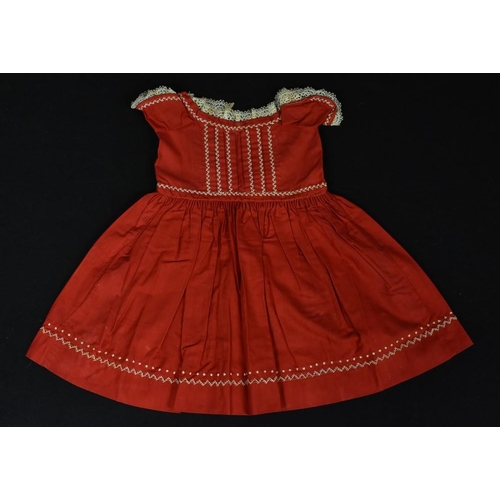 3423 - A late 19th Century girl's red cotton dress, lace trim, white feather stitch embroidered detail