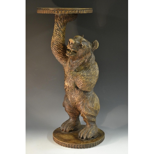 5067 - A Black Forest novelty dumb waiter, naturalistically carved as a bear, he stands, holding aloft a ci... 