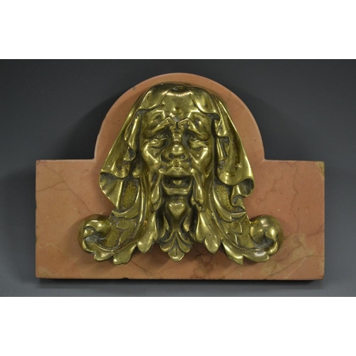 5070 - A bronze desk weight, cast in the Renaissance manner as a mask, rose marble base, 20.5cm wide