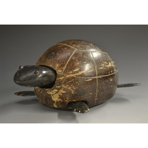 5074 - A coconut and ebony novelty toy, as a turtle, articulated head and legs, 18cm long