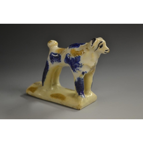 5080 - A Continental pottery novelty whistle, as a dog, mottled blue markings, 9.5cm high