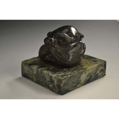 5084 - A dark patinated bronze mounted desk weight, as the head of a walrus, square marble base, 7.5cm wide