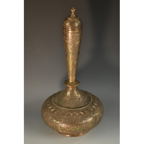 5112 - A large 19th century Islamic copper rose water bottle, profusely chased overall in the Indo-Persian ... 