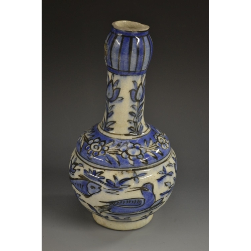 5129 - A Middle Eastern bulbous bottle vase, decorated in the Iznik palette with fish and stylized flowers,... 