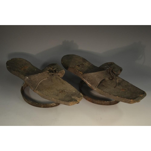 5137 - A pair of 18th century pattens/shoes, leather quarters embossed with neoclassical urns and scrolls, ... 