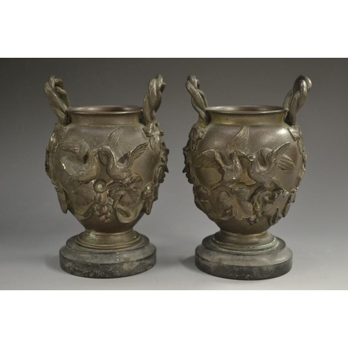 5141 - A pair of 19th century French dark patinated bronze ovoid vases, each cast with fruiting vine, lofty... 