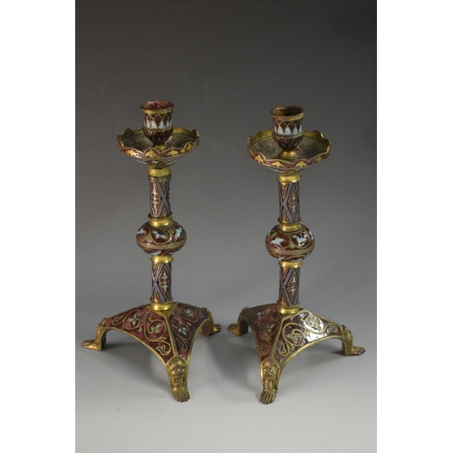 5150 - A pair of brass and cloisonne candlesticks, everted drip pans, knopped columns, triangular bases, ma... 