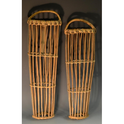 5155 - A pair of early 20th century cane and wicker boot trees, 49cm long, c.1910