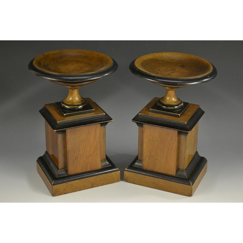 5163 - A pair of late 19th century mahogany and ebonised saucer shaped library mantel comports, in the Neo-... 