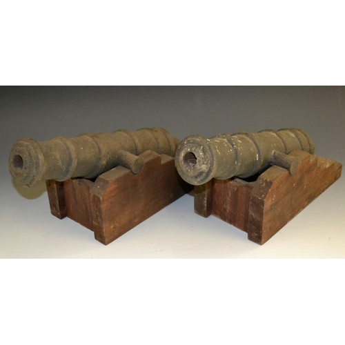 5164 - A pair of novelty iron fireside cannons, of typical form, stepped pine gun carriages, 35cm long, 16c... 