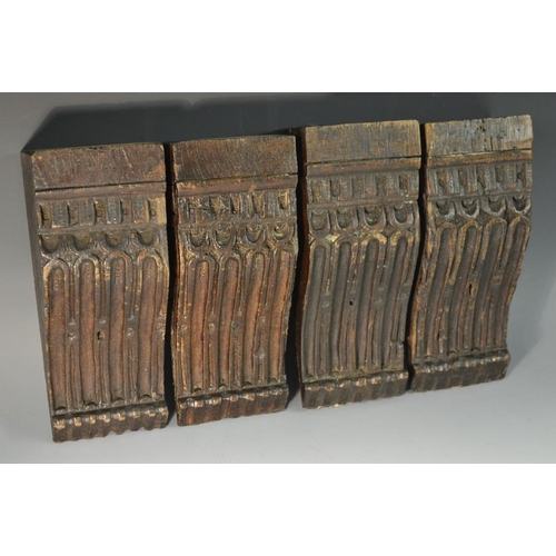 5174 - A set of four 16th century oak architectural corbels, each carved with a debased dental frieze above... 