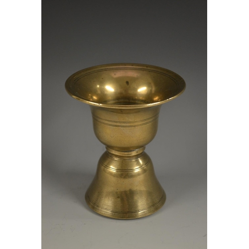 5184 - A Tibetan bronze waisted bell shaped butter lamp, of Islamic shape, 11cm high, 18th century