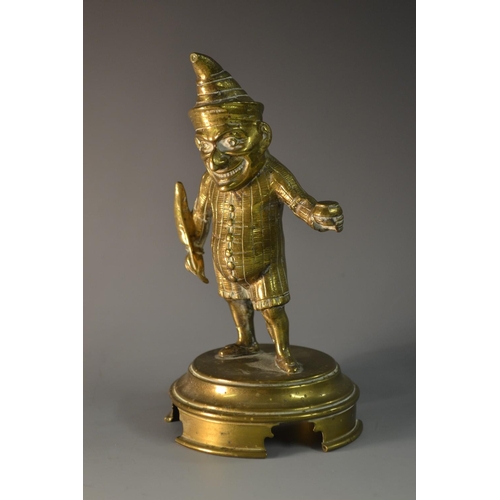 5192 - A Victorian gilt brass novelty taper lighter, cast as Mr Punch, he stands holding a quill and well, ... 