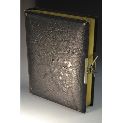 5861 - A late Victorian leather photograph album, containing b/w cabinet cards and carte de visite portrait... 