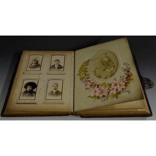 5862 - A late Victorian leather photograph album, containing carte de visites and cabinet cards of ladies, ... 