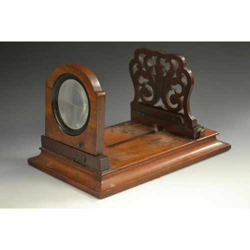 5865 - A Victorian mahogany tabletop stereoscopic viewer, the folding support pierced with leafy scroll fre... 