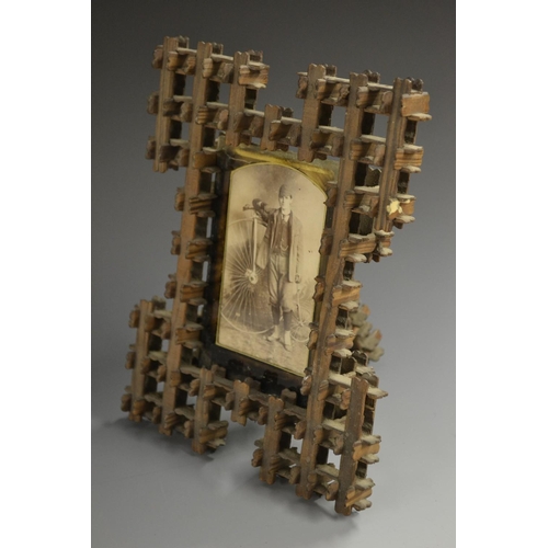 5866 - Cycling - a Victorian tramp art easel photograph frame, containing a photograph of a man with a penn... 