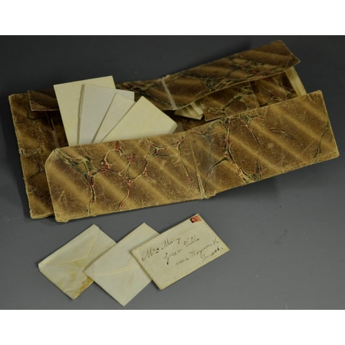 5894 - A 19th century lady's MS and paper parlour game, the folded marbled covers enclosing divisions and b... 