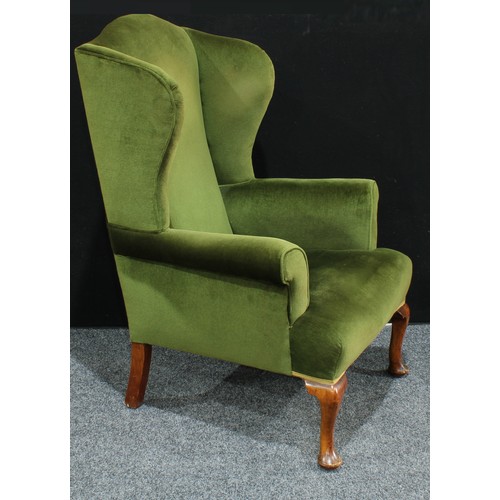 14 - A George II style wing back arm chair, scroll arms, cabriole legs, pad feet, 119cm high.