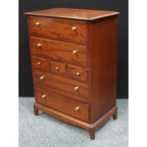 66 - A Stag chest of drawers, oversailing rectangular top above an arrangement of drawers, shaped apron, ... 