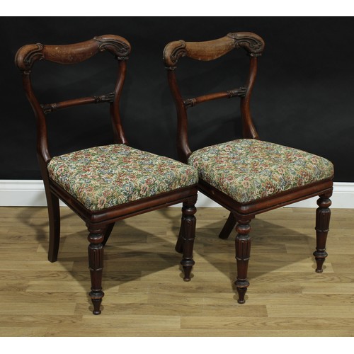 67 - A set of four early Victorian mahogany dining chairs, cartouche shaped backs carved with scrolling l... 