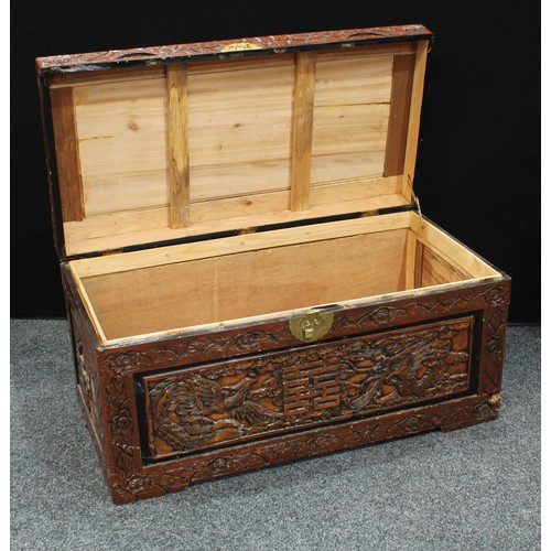 71 - A Chinese inspired hardwood blanket chest, profusely applied with dragons, birds, character marks, f... 