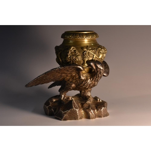 3065 - A 19th century novelty inkwell, cast with an eagle with wings outspread, holding a bronzed well with... 