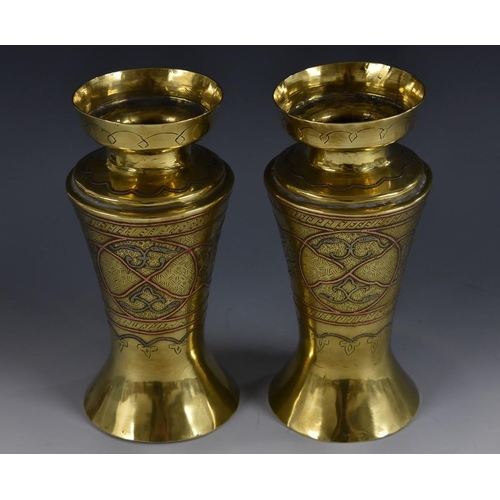 3205 - A pair of Middle Eastern Islamic silver and copper damascened brass vases, worked in the Cairo ware ... 