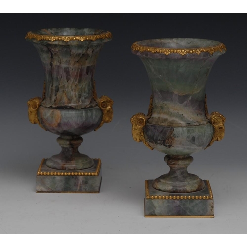 115 - A pair of 19th century ormolu mounted fluorspar campana mantel urns, in tones of green, purple and w... 