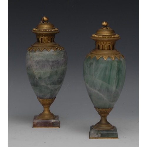 117 - A pair of Louis XVI style ormolu mounted fluorspar ovoid castlettes, in tones of green and purple, d... 