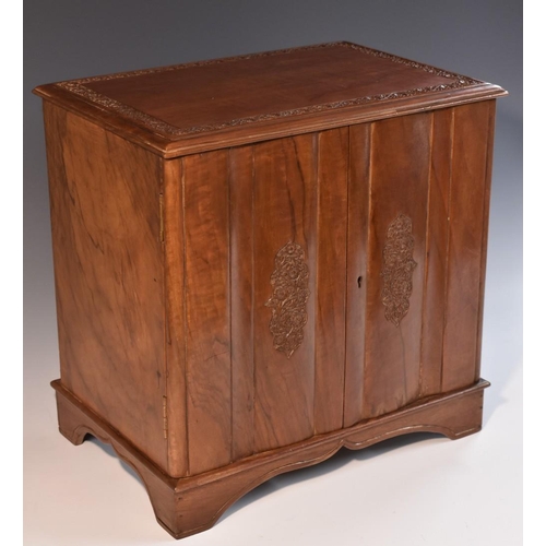 3321 - An Indian hardwood table cabinet, rectabngular top above a pair of doors enclosing three drawers, ca... 