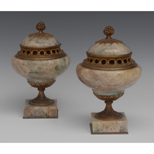 118 - A pair of Louis XVI style ormolu mounted fluorspar pastille urns, in tones of green, purple and whit... 