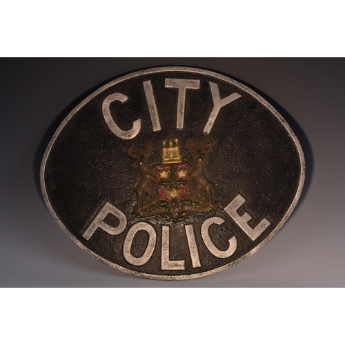 3377 - Policing Interest - an aluminium oval sign, City Police, centred by municipal arms, 37cm x 45cm, mid... 