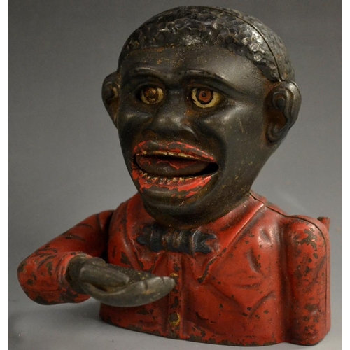 5075 - An early 20th century cast iron Sambo bank, as a jolly black man, 14cm high, c.1920