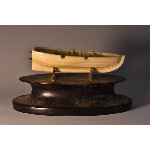 3408 - Marine Folk Art - an early 19th century whale tooth carving, of an open boat, 8.5cm long