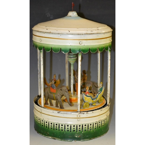 5094 - A clockwork tinplate Carousel -  creamy white body, red flag crest above a blue ring topper roof,  w... 