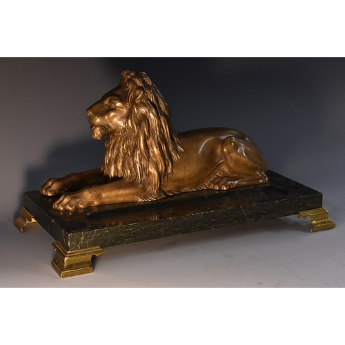 3435 - French School (19th century), a gilt patinated bronze, of a recumbent lion, mounted on a verte antic... 