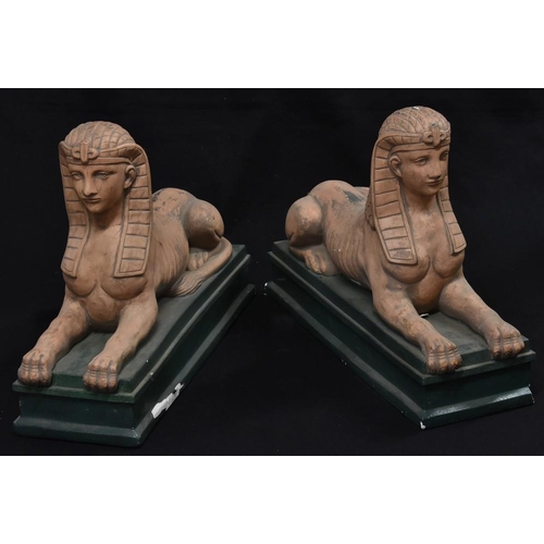 3458 - A pair of large Grand Tour plaster sphinxes, painted in terracotta tones, stepped rectangular green ... 