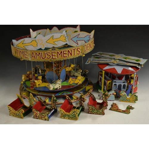 5284 - A scratch built model of a fairground ride, roundabout, dragon boat seats, bird and other ride on an... 