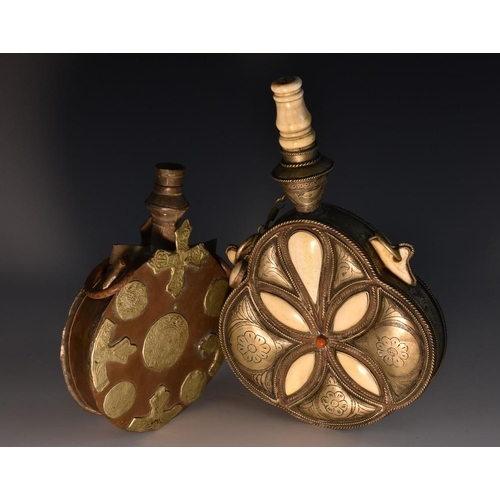 3738 - A Moroccan silvered, bone and special hardwood quatrefoil powder flask, chased and applied with geom... 