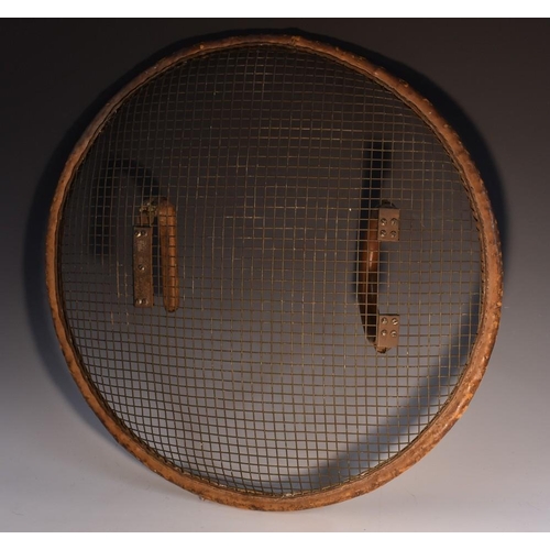 3760 - An early 20th century leather and mesh shield, possibly Police related, 64cm diam