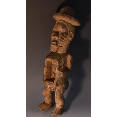 3855 - Tribal Art - a Nkysi fetish or power figure, standing, his arms flanking a niche at his waist, 39cm ... 