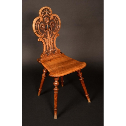 179 - A harlequin set of four Continental walnut side chairs, shaped and pierced backs variously carved wi... 