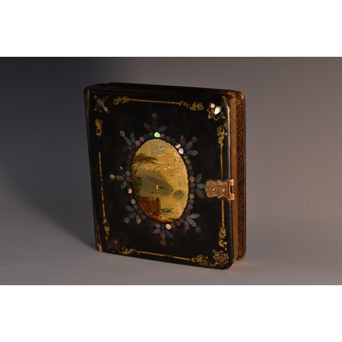 3985 - A Victorian papier mache novelty photograph case, as a book, the hinged cover painted with a landsca... 