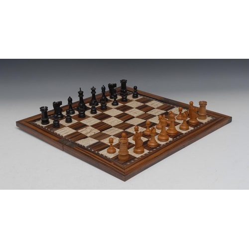 91 - An Anglo-Indian coromandel and fossilized mammoth tooth folding chess board, chevron border, 45.5cm ... 