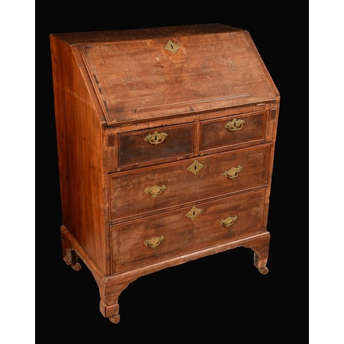 1574 - A George I walnut bureau, of small proportions, fall front with reading ledge enclosing a stepped ar... 