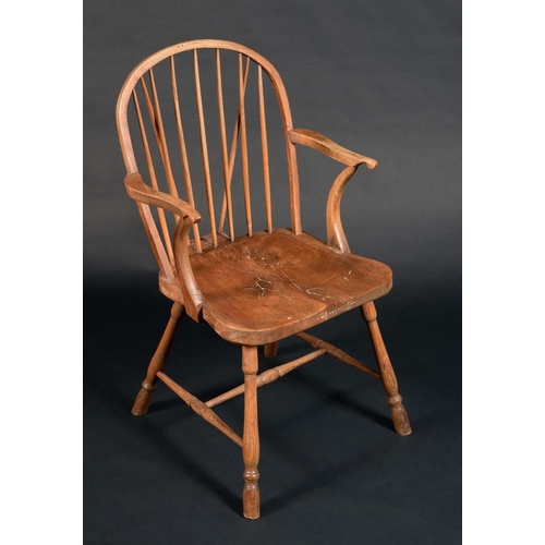 1579 - An early 19th century elm Windsor elbow chair, arched stick back, deep saddle seat, turned legs and ... 