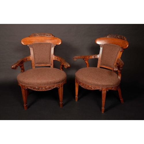 1584 - A pair of Victorian walnut library elbow chairs, of broad proportions, curved cresting rails, outswe... 