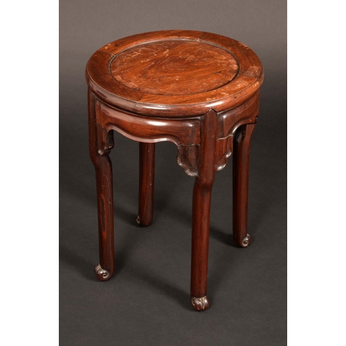 1585 - A Chinese padouk wood circular jardiniere stand, panelled top above a shaped frieze, scroll feet, 52... 